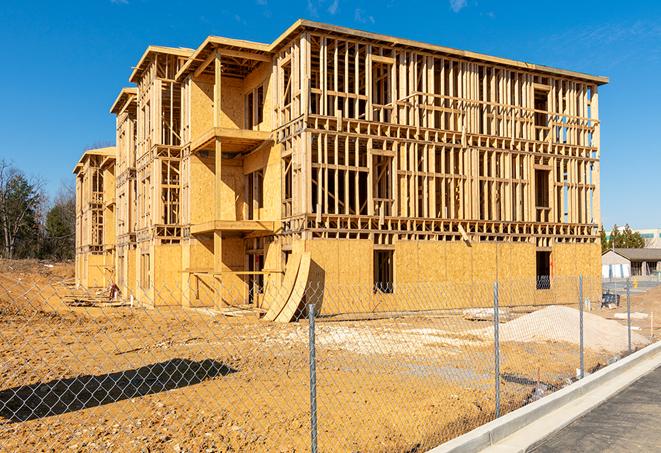 a temporary chain link fence in front of a building under construction, ensuring public safety in New Albany, OH